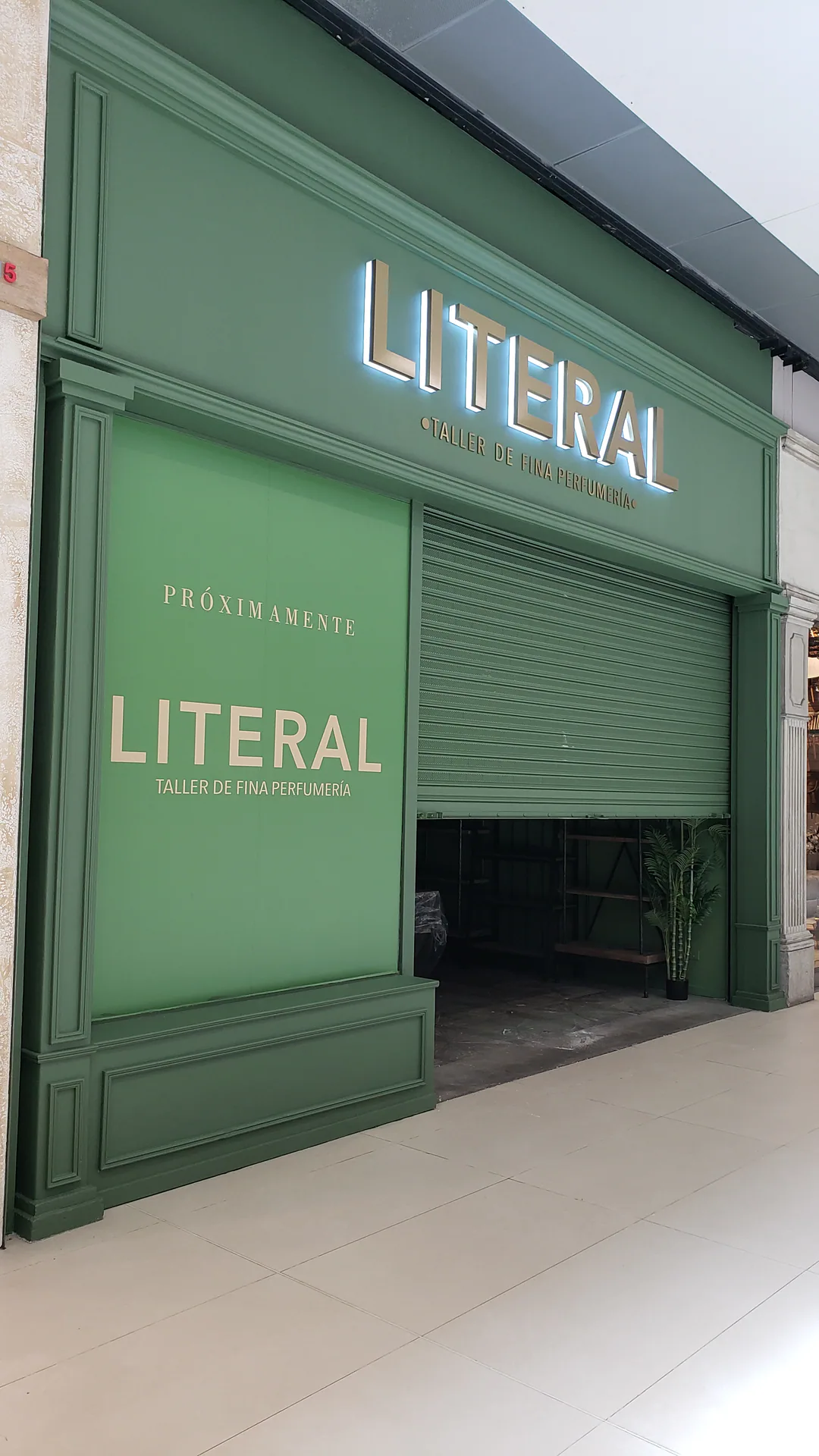 Fachada verde de Literal con letras iluminadas